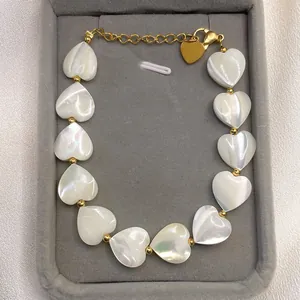 Detail of shell heart beaded necklace with 18k gold plating and lobster clasp