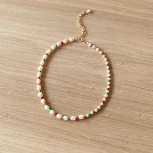 Colorful handmade necklace with natural freshwater pearls and vibrant beads in boho style