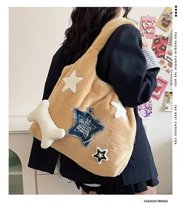 Detail of camel plush tote bag featuring star patches and a cute bone-shaped charm