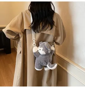 Plush husky backpack shown on model wearing a khaki coat in a minimalist setting