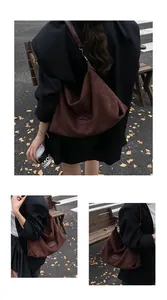 Detail view of large dark brown suede tote bag featuring textured leather and logo patch