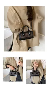 Detail of leopard print handbag with silver hardware and black studs shown with model