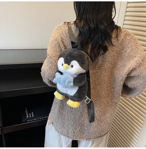 Detailed plush penguin backpack with soft fabric and blue fish doll accessory