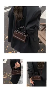 Detail of chocolate brown leopard拼接 cross-body bag with stylish metal buttons and strap