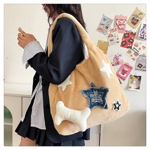 Macro view of plush apricot tote bag featuring star patches and bone accessory detail