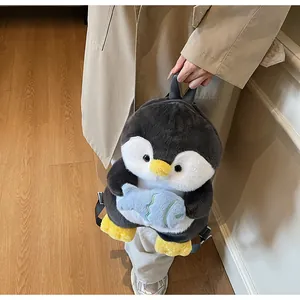 Close-up of cute plush penguin backpack with soft faux fur texture and small blue fish detail