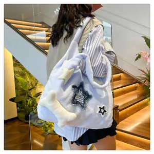 Detail of light blue fuzzy tote bag with star patches and 3D bone charm detail