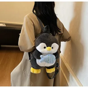 Detail of cute grey plush penguin backpack with adjustable straps worn by a model