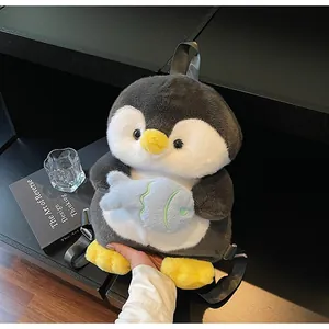 Detail of cute penguin plush backpack with adjustable straps and soft fish accessory