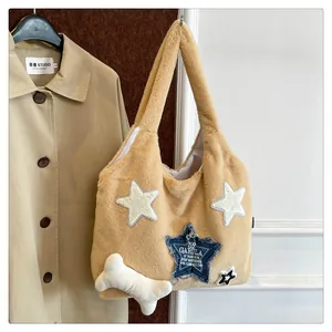 Close-up of fuzzy tote bag with star patches and a cute white bone plush charm