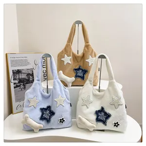 Detail of plush star tote bags in blue and white with a cute bone-shaped charm