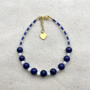 Handmade beaded bracelet with blue lapis, moonstone, and gold heart charm