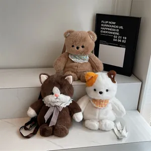 Plush bear and cat crossbody bags with cute lace bibs and adjustable straps on marble