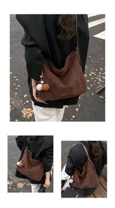 Detail of dark brown tote bag with white contrast stitching and soft faux suede texture