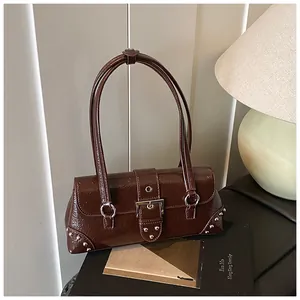 Detail view of dark brown vintage underarm bag with glossy leather and silver buckles