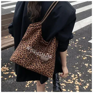 Outdoor shot of stylish leopard print large tote bag with elegant heart pendant