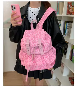 Detail of pink leopard print backpack with ruffled hem and magnetic buckle closure