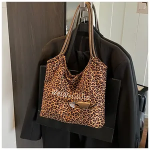 Close-up of leopard print tote bag with artistic WeiWeiShia text and brown shoulder straps