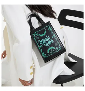 Detail of book-shaped crossbody bag with Wicked Witch of the West green print