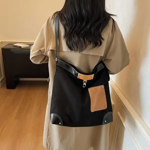 Chic black canvas tote with brown suede pockets, spacious vintage bucket bag for women