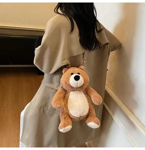 Close-up of a cute brown plush bear backpack with cream accents and fabric straps