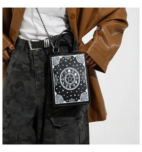 Detailed view of dark magic book handbag with white mystical moon and star patterns