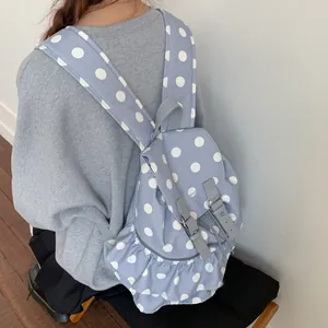 Light blue polka dot backpack with ruffle trim and wide adjustable shoulder straps