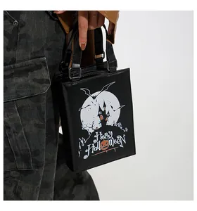 Detailed view of Halloween themed black tote bag with moon and castle print on a model