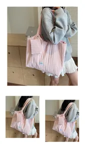 Détail du sac cabas rose en toile plissée avec pochette latérale et logo tissé