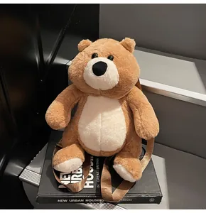 Detail of cute teddy bear plush backpack with brown fur and white chest on grey steps