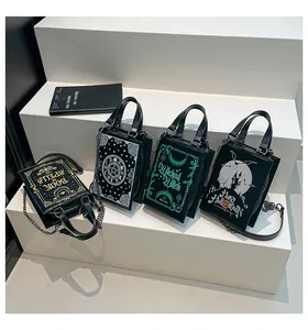 Macro view of gothic spell book style handbags with chain straps and dark patterns