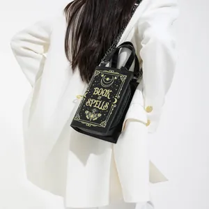 Book of Spells shaped crossbody bag with gold lunar patterns and metal chain strap