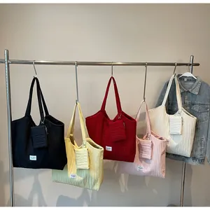 Vue de cinq sacs cabas en toile colorée avec texture plissée et petits porte-monnaie