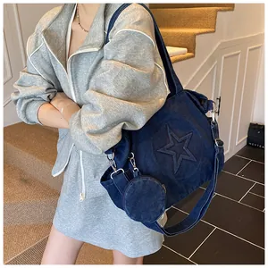 Detail of dark blue denim tote bag with embossed star and matching round coin purse