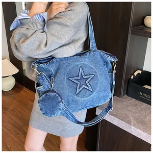 Detail view of denim tote bag with embossed star pattern and detachable round pouch
