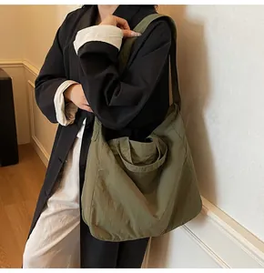 Detail of olive green canvas tote bag with wide straps for casual daily commuting