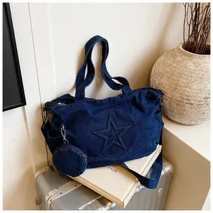 Detail of blue denim tote bag with embossed star pattern and small round coin purse