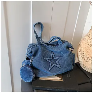 Detail of denim tote bag with star patch embroidery and detachable round coin purse