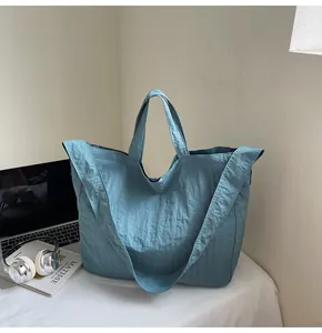 Detailed view of the vintage teal canvas tote bag with wide shoulder strap and soft texture