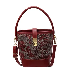 Traditional Chinese style red embroidery bucket bag with phoenix patterns and gold metal lock