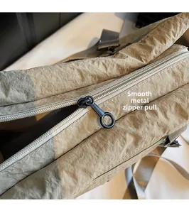 Detail of premium nylon bag showing black metal ring zipper and pleated fabric texture