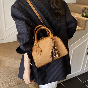 Vintage brown suede shell handbag with beaded charm and leather strap for women