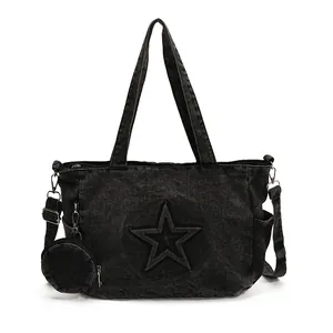 Black washed denim star tote bag with double handles and adjustable crossbody strap