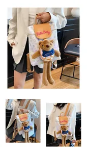 Detail of cartoon bear backpack with Hello Baby embroidery and long dangling plush legs