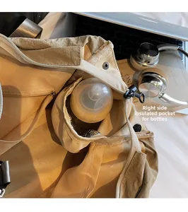 Close-up of insulated side pocket with aluminum foil lining for baby bottles in large tote