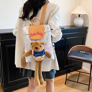 Graffiti canvas backpack with leather flap and cute long-legged plush bear doll pendant