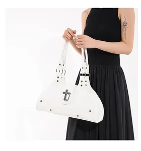 White vintage biker style tote bag with metal cross and rivet details on black dress