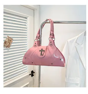 Pink patent leather tote bag detail with metal cross and rivet hardware accents