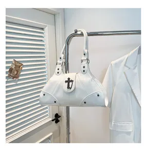 Detail of white oil wax leather tote with black metal cross buckle and rivet accents