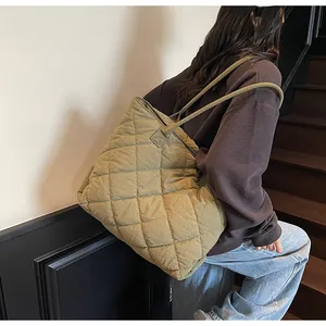 Close-up of olive green quilted tote bag showing large capacity and soft padded fabric